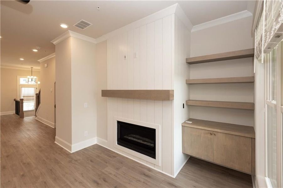 Flooring upgrades throughout- no carpet- Hardwood flooring and stairs.  Beautiful neutral colored hardwoods - Riverside - with wood cabinet built-in and floating shelves and mantelpiece stained to match.