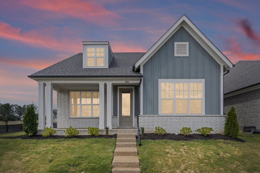View of front of house featuring board and batten siding, a yard, brick siding, a porch, and roof with shingles View of front of house featuring board and batten siding, a yard, brick siding, a porch, and roof with shingles