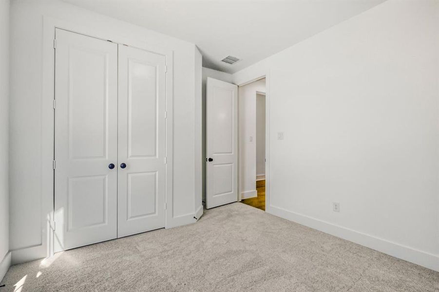 Unfurnished bedroom featuring carpet floors and a closet