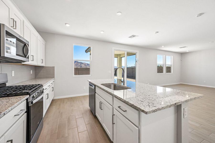 A kitchen with white cabinets.