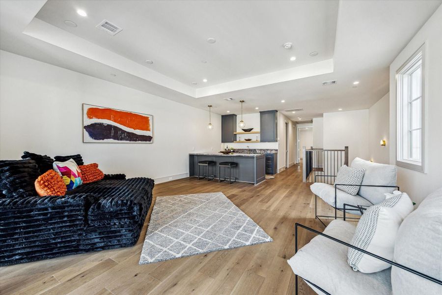 The fourth floor boasts a generous City Room, perfect for entertaining or relaxing. The tray ceiling helps define the space and creates distinction between the room and the wet bar. The fourth floor boasts a generous City Room, perfect for entertaining or relaxing. The tray ceiling helps define the space and creates distinction between the room and the wet bar.