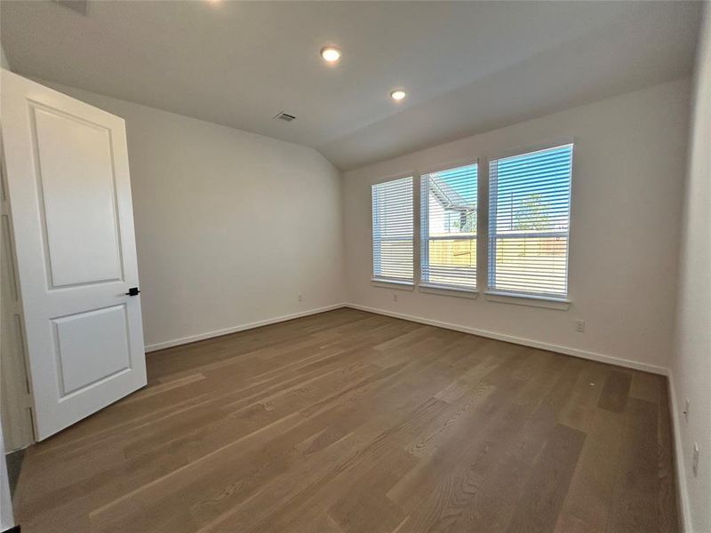 The main bedroom is bathed in natural light, creating a bright and inviting atmosphere. Large windows enhance the space, offering picturesque views and a serene ambiance.