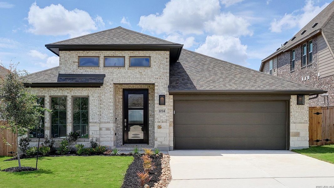 Front exterior of a new home in VIDA, San Antonio, TX, highlighting curb appeal (Image 18).