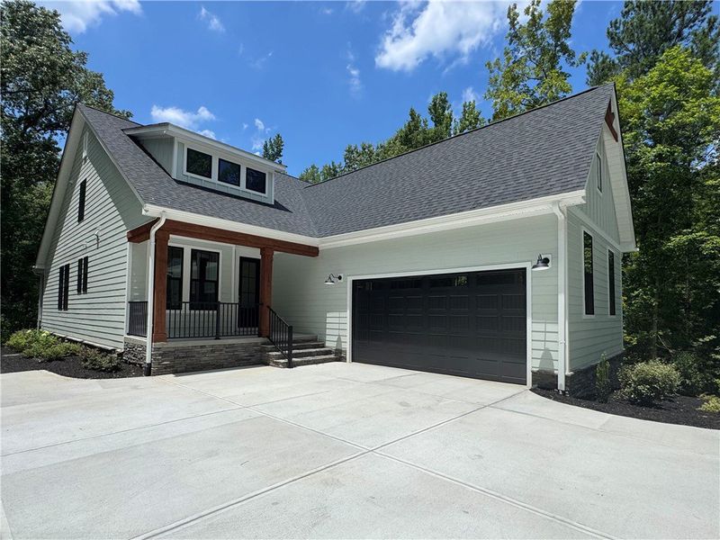 An inviting light-colored exterior features a ston An inviting light-colored exterior features a ston
