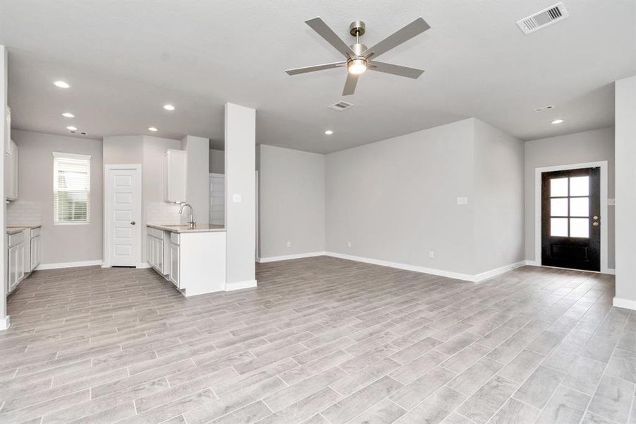 Inviting dining room seamlessly connected to the adjacent kitchen, where the warm ambiance and modern design create a perfect space for shared meals and culinary gatherings. Sample photo of completed home with similar floor plan. As-built interior colors and selections may vary.