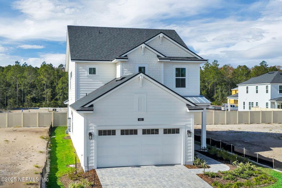 Front exterior of a new home in Seabrook Village at Seabrook, Ponte Vedra, FL, highlighting curb appeal (Image 20).