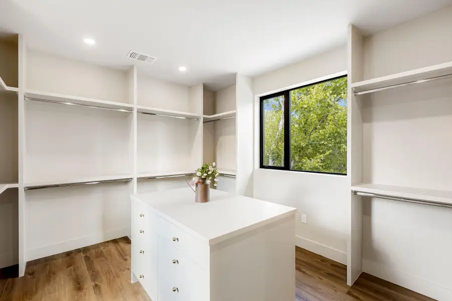 Walk in closet with wood finished floors Walk in closet with wood finished floors