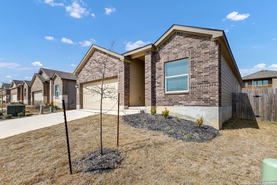Front exterior of a new home in Hidden Trails: Coastline Collection, Bulverde, TX, highlighting curb appeal (Image 18).