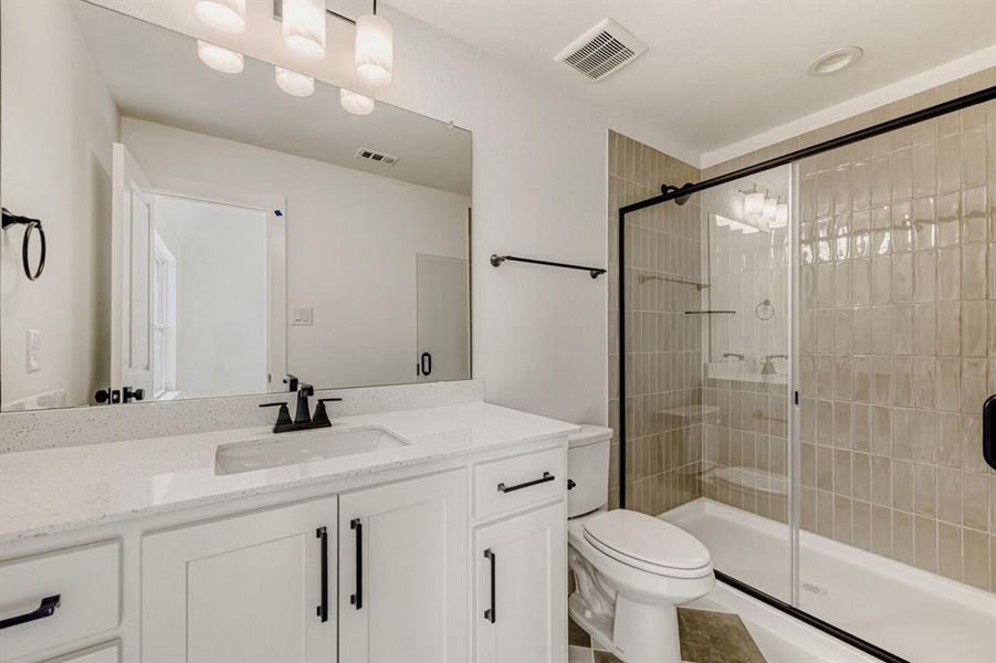 Full bath featuring vanity and a shower stall