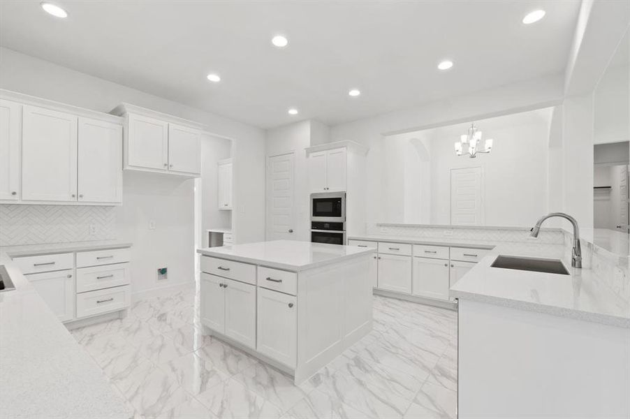 large kitchen with quartz countertops, butler pantry