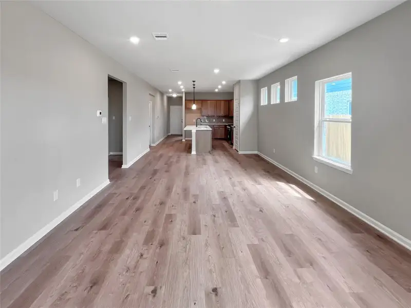 The Oakshire II- Family Room into Kitchen. Home under construction.  Sample image for illustration; upgrades, options, and colors may vary.