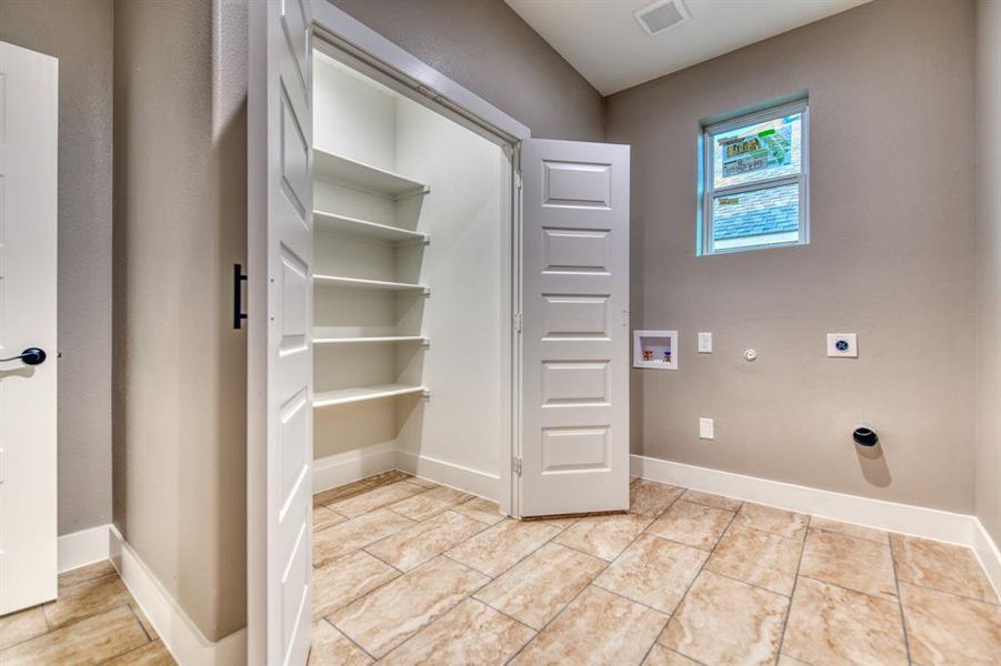 Washroom with washer hookup, electric dryer hookup, and hookup for a gas dryer