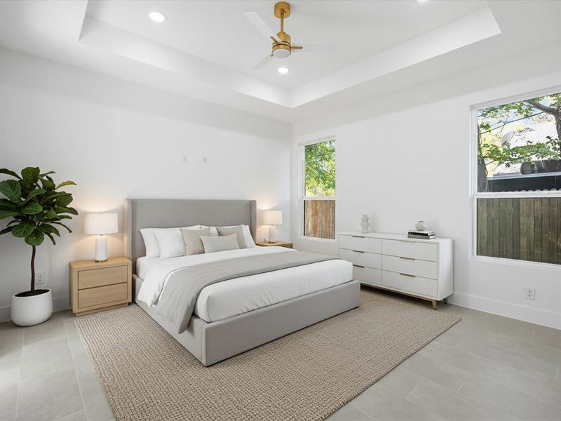 Bedroom with a tray ceiling, recessed lighting, and a ceiling fan