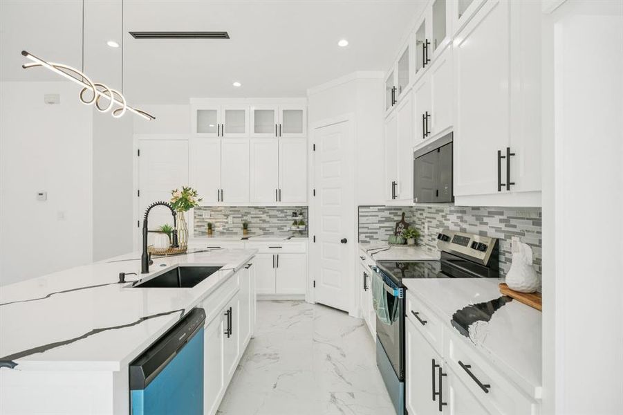 Kitchen featuring glass insert cabinets, stainless steel electric stove, backsplash, hanging light fixtures, and light marble finish flooring