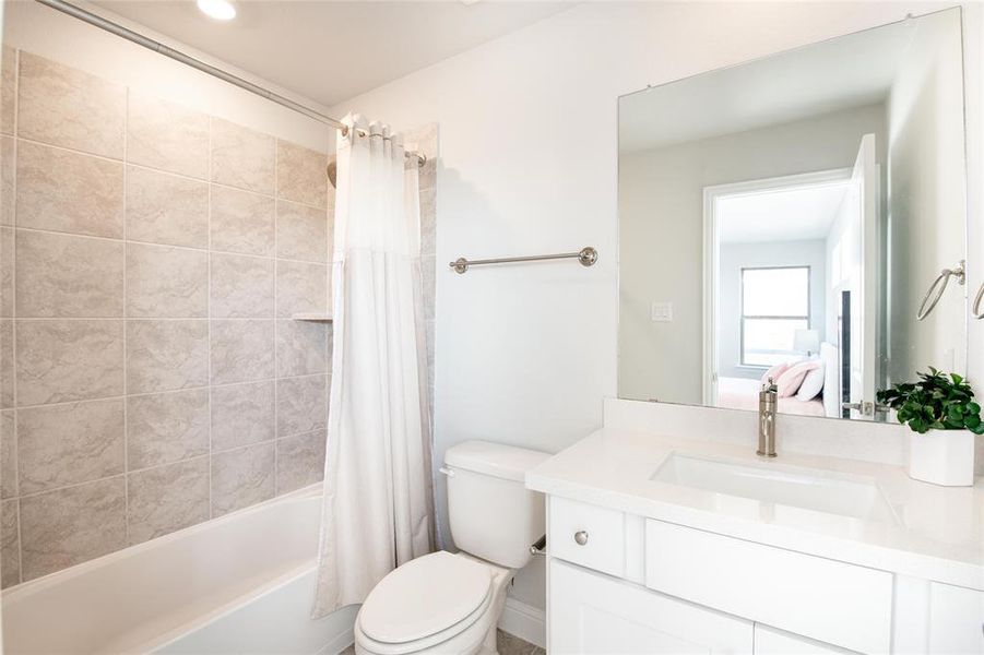 Complete with a private full bath featuring quartz countertops, modern finishes, and a tub/shower combination, this ensuite creates a comfortable and self-contained retreat for guests or family members. Complete with a private full bath featuring quartz countertops, modern finishes, and a tub/shower combination, this ensuite creates a comfortable and self-contained retreat for guests or family members.