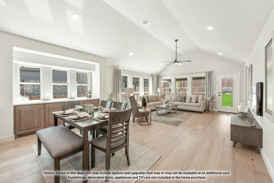 Open-concept dining and living area with vaulted ceiling, hardwood floors, and large windows Open-concept dining and living area with vaulted ceiling, hardwood floors, and large windows
