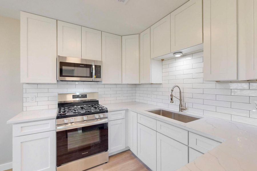white subway back splash with the grey grout really pops.