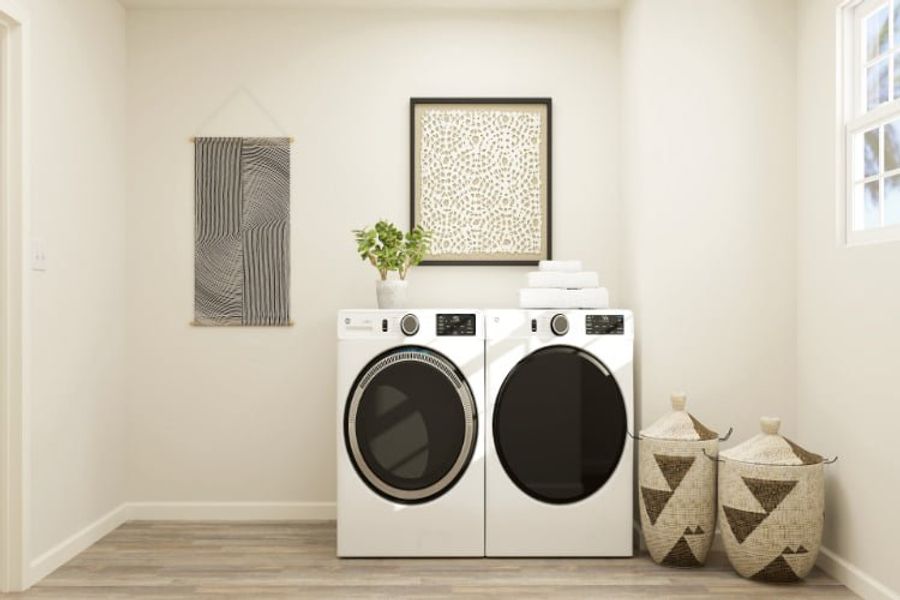 A white laundry room with a black and white washer and dryer. A white laundry room with a black and white washer and dryer.