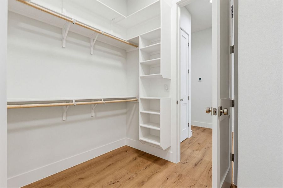 Functional custom built-ins and hanging rods define this organized storage space.