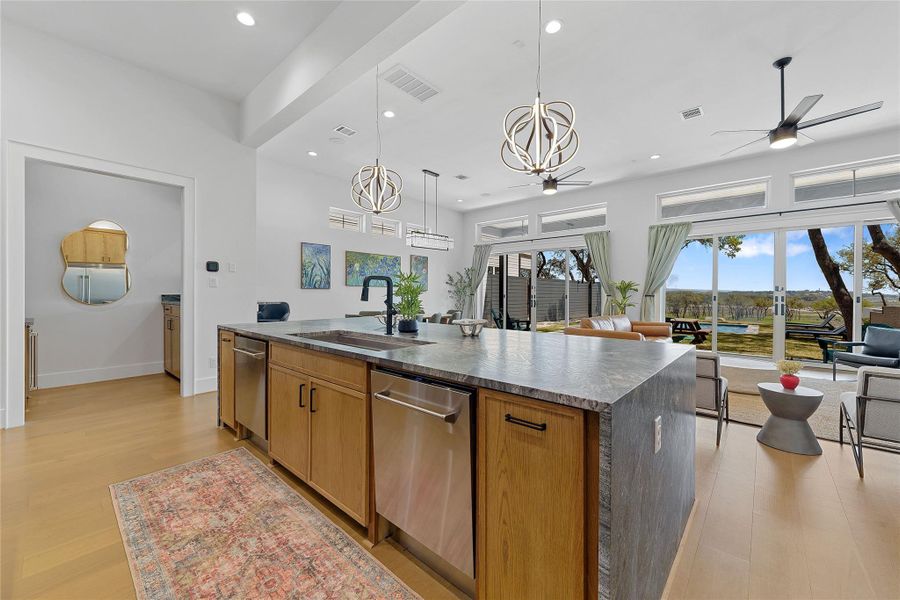 Enjoy breathtaking views from this sleek, open-concept kitchen featuring a waterfall-edge island, modern pendant lighting, and seamless flow into the bright living area. Ideal for entertaining or everyday luxury near Canyon Lake.