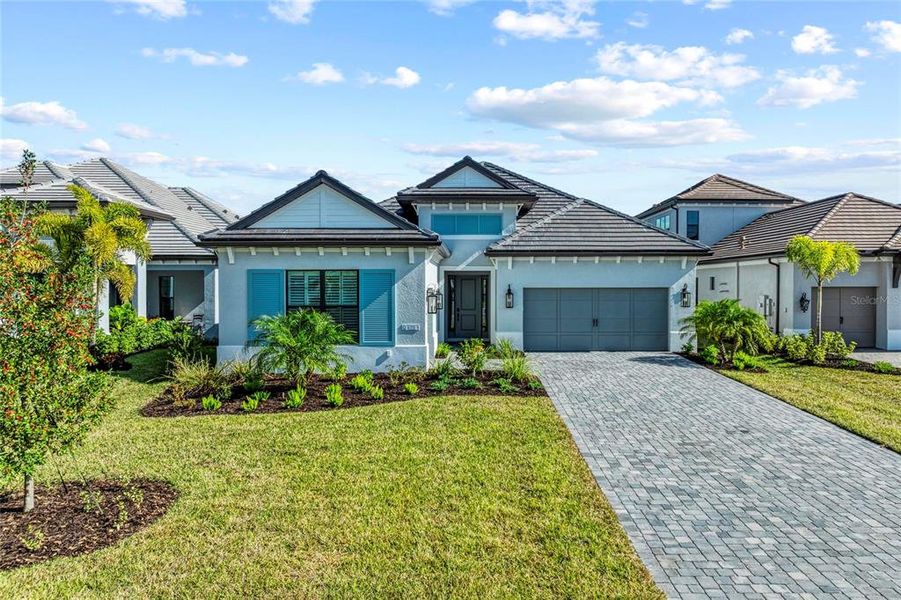 Front exterior of a new home in The Alcove at Waterside, Sarasota, FL, highlighting curb appeal (Image 27). Front exterior of a new home in The Alcove at Waterside, Sarasota, FL, highlighting curb appeal (Image 27).