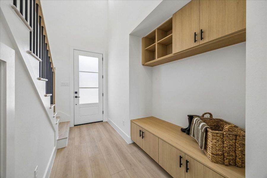 Custom built in mudroom cabinetry crafted in Vicenza Oak creates a beautiful and functional everyday landing space.