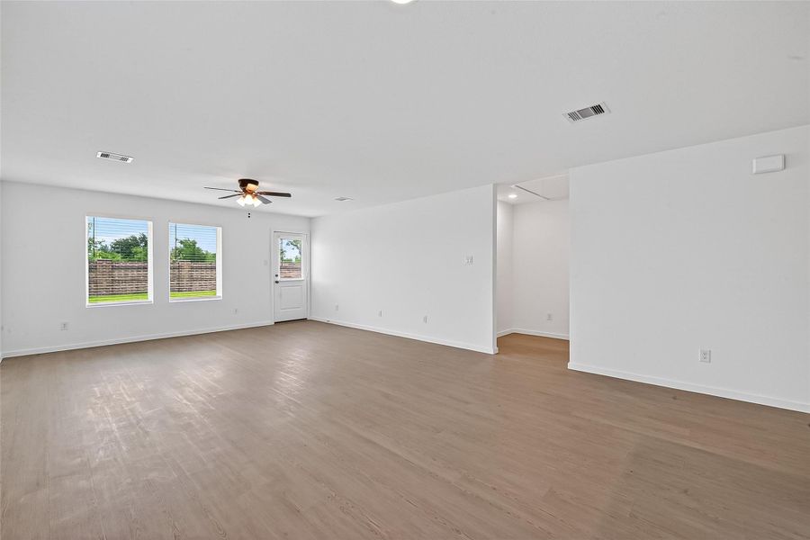 The large living room has easy access to the primary suite located at the back of the house for extra privacy.