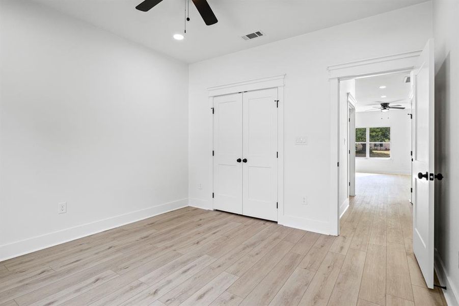 Unfurnished bedroom with recessed lighting, light wood-type flooring, a closet, and ceiling fan