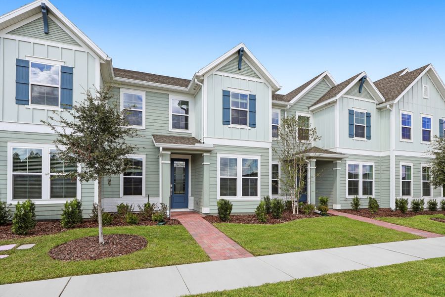 Front exterior of a new home in Shearwater: Shearwater 24ft Townhomes, St. Augustine, FL, highlighting curb appeal (Image 1).