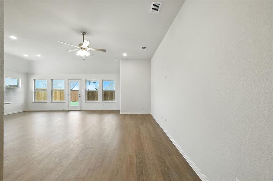 Unfurnished living room with wood finished floors, a ceiling fan, and recessed lighting Unfurnished living room with wood finished floors, a ceiling fan, and recessed lighting