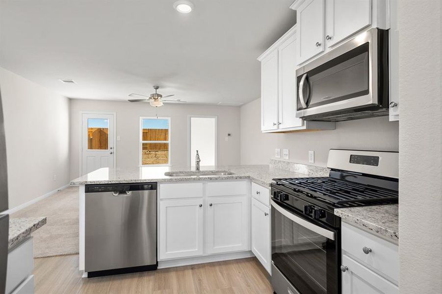 Stainless-Steel appliances with white cabinets makes this kitchen chef-ready.