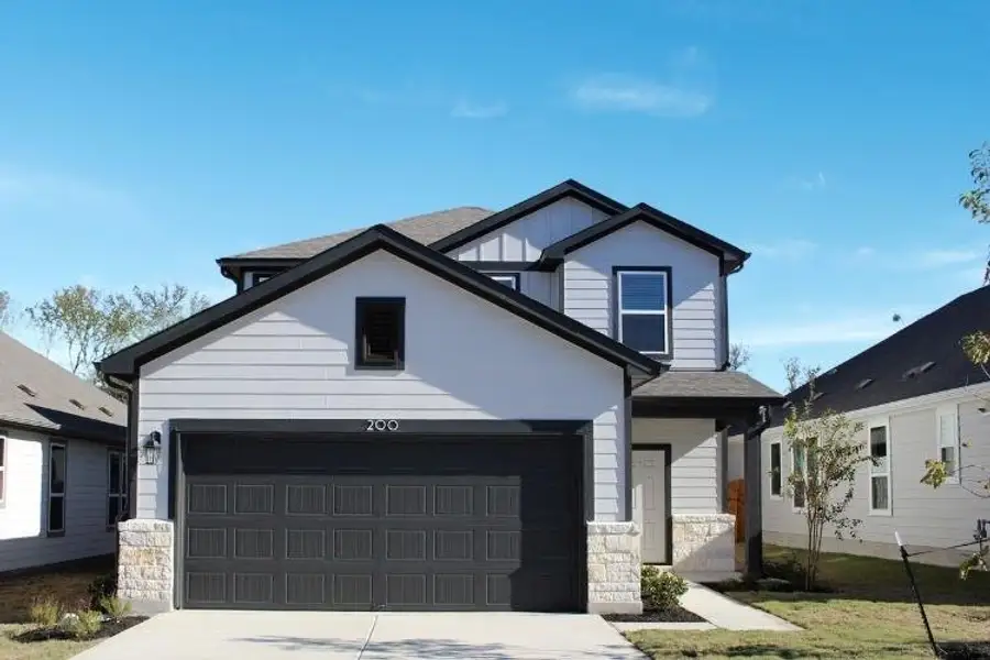 Front exterior of a new home in The Overlook at Trinity Ranch, Elgin, TX, highlighting curb appeal (Image 2). Front exterior of a new home in The Overlook at Trinity Ranch, Elgin, TX, highlighting curb appeal (Image 2).