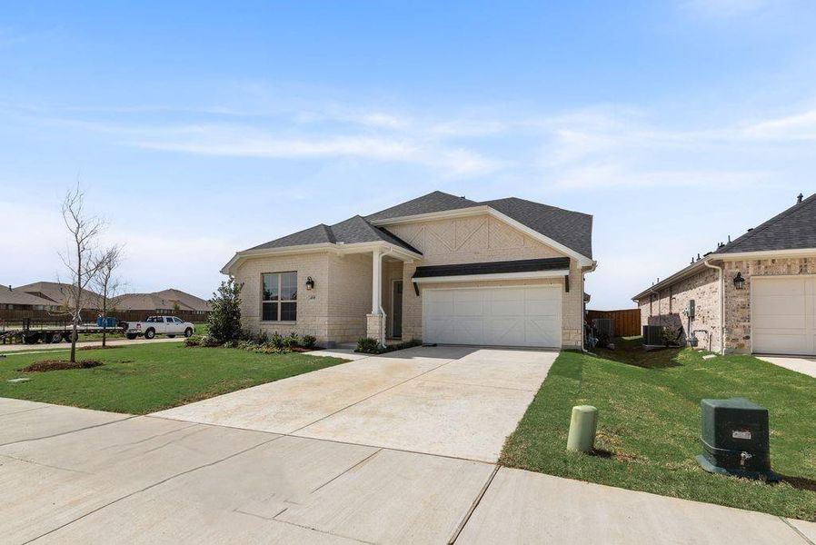 Front exterior of a new home in Spiritas Ranch, Little Elm, TX, highlighting curb appeal (Image 24).