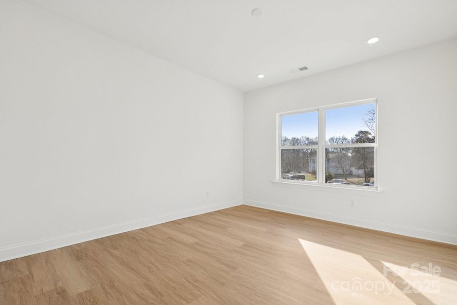 Large primary bedroom with huge walk-in closet and en-suite bathroom complete with a tiled shower wall Large primary bedroom with huge walk-in closet and en-suite bathroom complete with a tiled shower wall