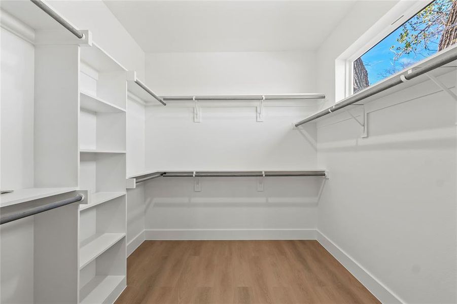 Spacious closet featuring light wood-type flooring