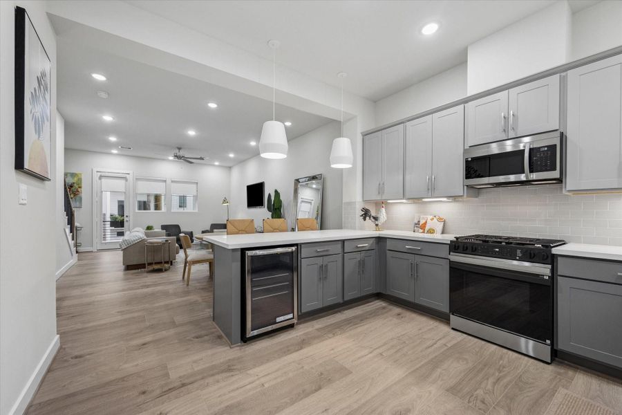 beverage area, gas range cooktop, open to living - Photo is of model at 6340, finishes are similar. beverage area, gas range cooktop, open to living - Photo is of model at 6340, finishes are similar.
