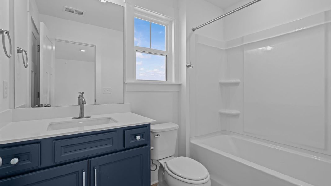 Refined hall bath with elevated finishes and a highly functional layout