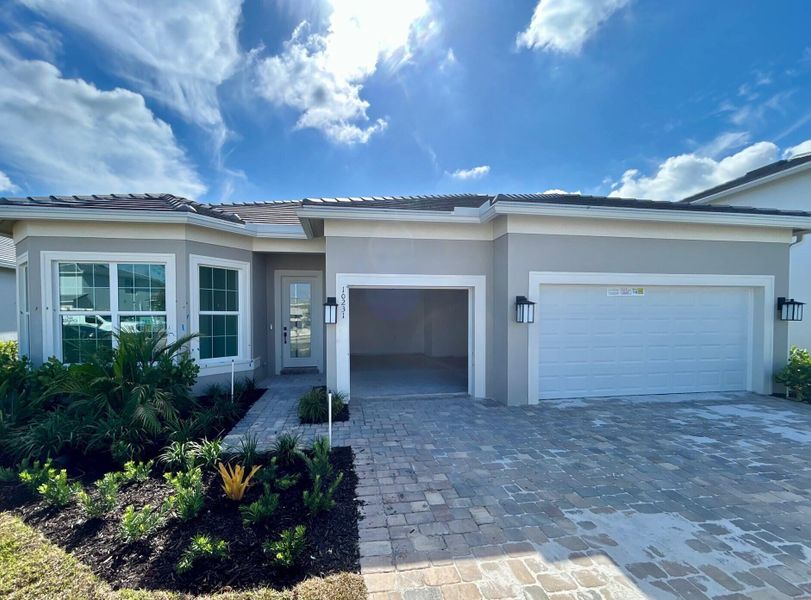 Front exterior of a new home in Highpointe, Stuart, FL, highlighting curb appeal (Image 20). Front exterior of a new home in Highpointe, Stuart, FL, highlighting curb appeal (Image 20).