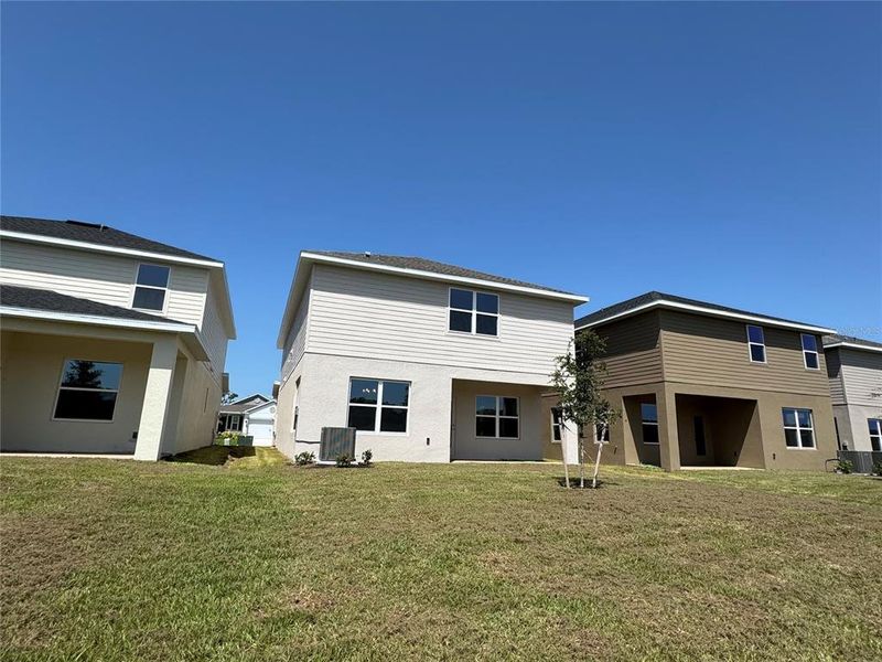 Front exterior of a new home in Harmony Central, Harmony, FL, highlighting curb appeal (Image 20). Front exterior of a new home in Harmony Central, Harmony, FL, highlighting curb appeal (Image 20).