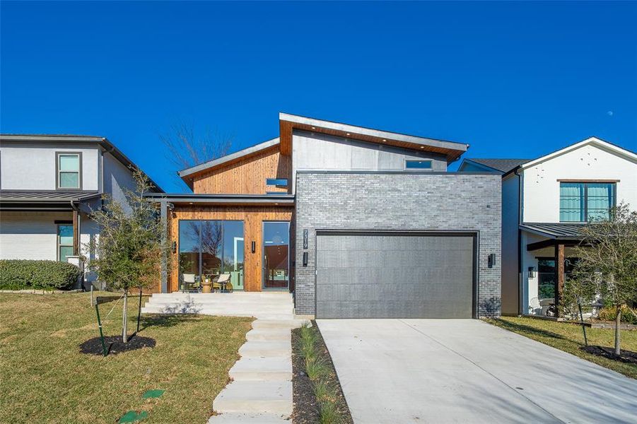 Contemporary home with a garage and a front lawn