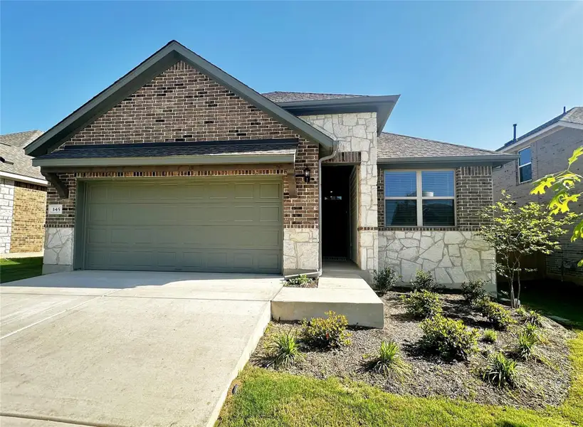 Front exterior of a new home in The Colony 50s, Bastrop, TX, highlighting curb appeal (Image 1).