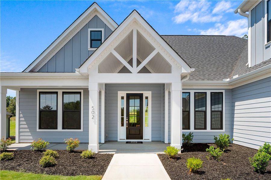 A welcoming front porch with white columns frames