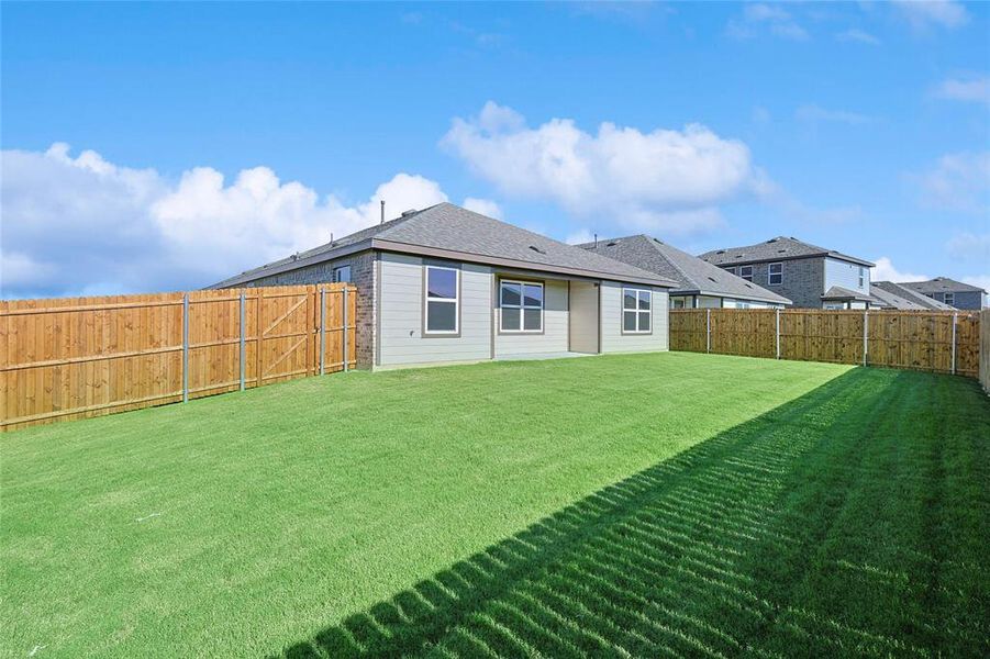 Rear view of property featuring a lawn