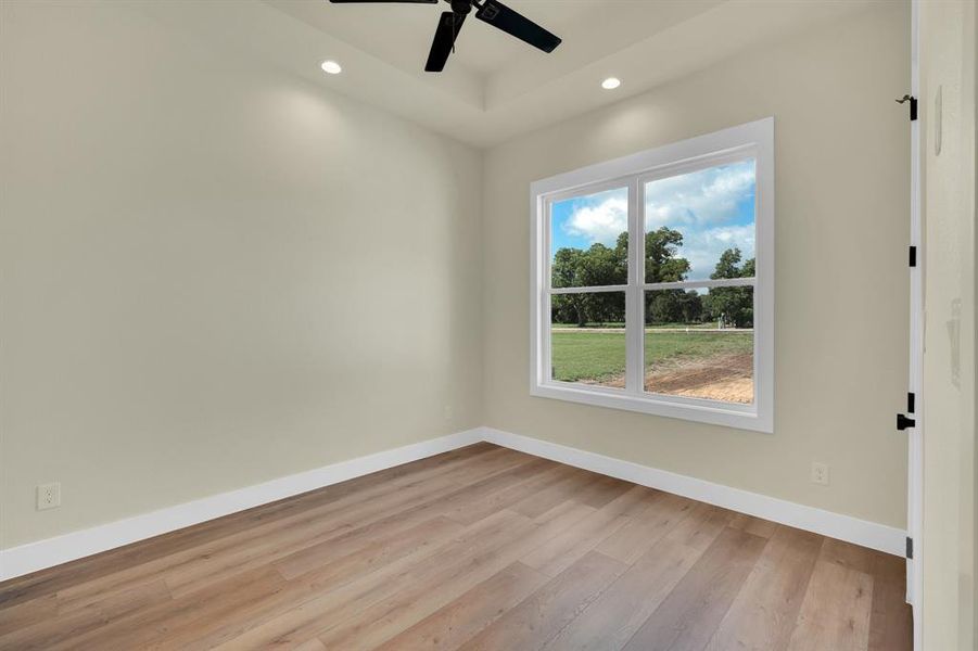 Empty room featuring ceiling fan and light wood-type flooring