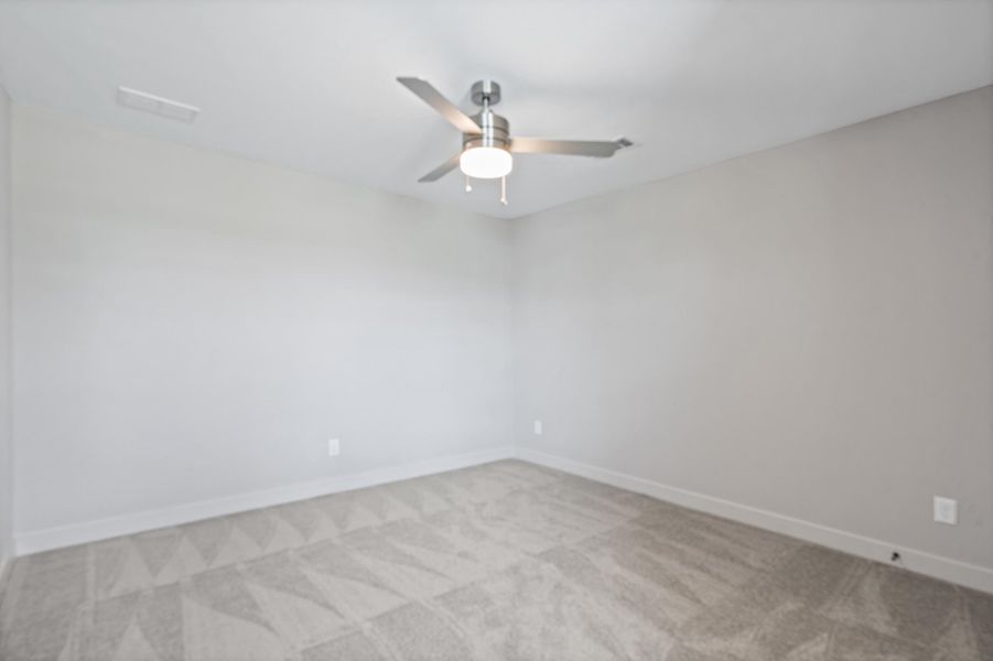 Ceiling fan with integrated lighting, recessed lighting, neutral wall paint, and patterned carpeting