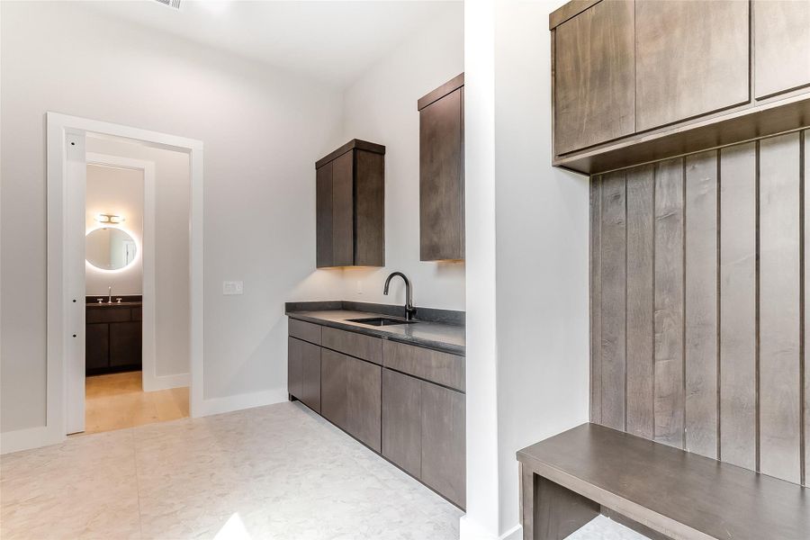 Laundry room with a sink and baseboards Laundry room with a sink and baseboards