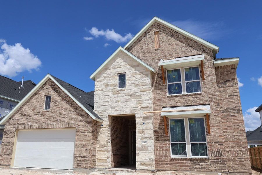 Front exterior of a new home in Woodson’s Reserve, Spring, TX, highlighting curb appeal (Image 2). Front exterior of a new home in Woodson’s Reserve, Spring, TX, highlighting curb appeal (Image 2).