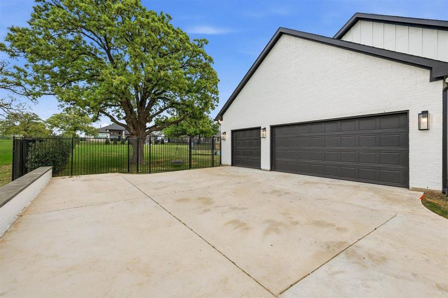 View of side of property with concrete driveway, board and batten siding, and brick siding