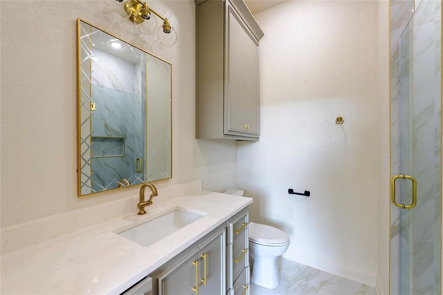 Full bathroom with vanity, a marble finish shower, and light marble finish flooring Full bathroom with vanity, a marble finish shower, and light marble finish flooring