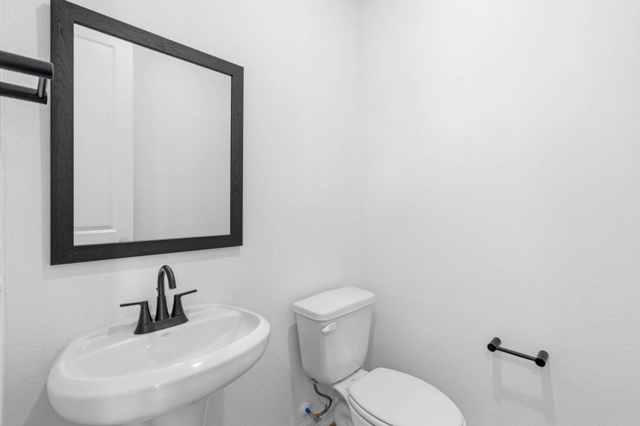 Convenient powder room located just off the living space for guests and everyday use.